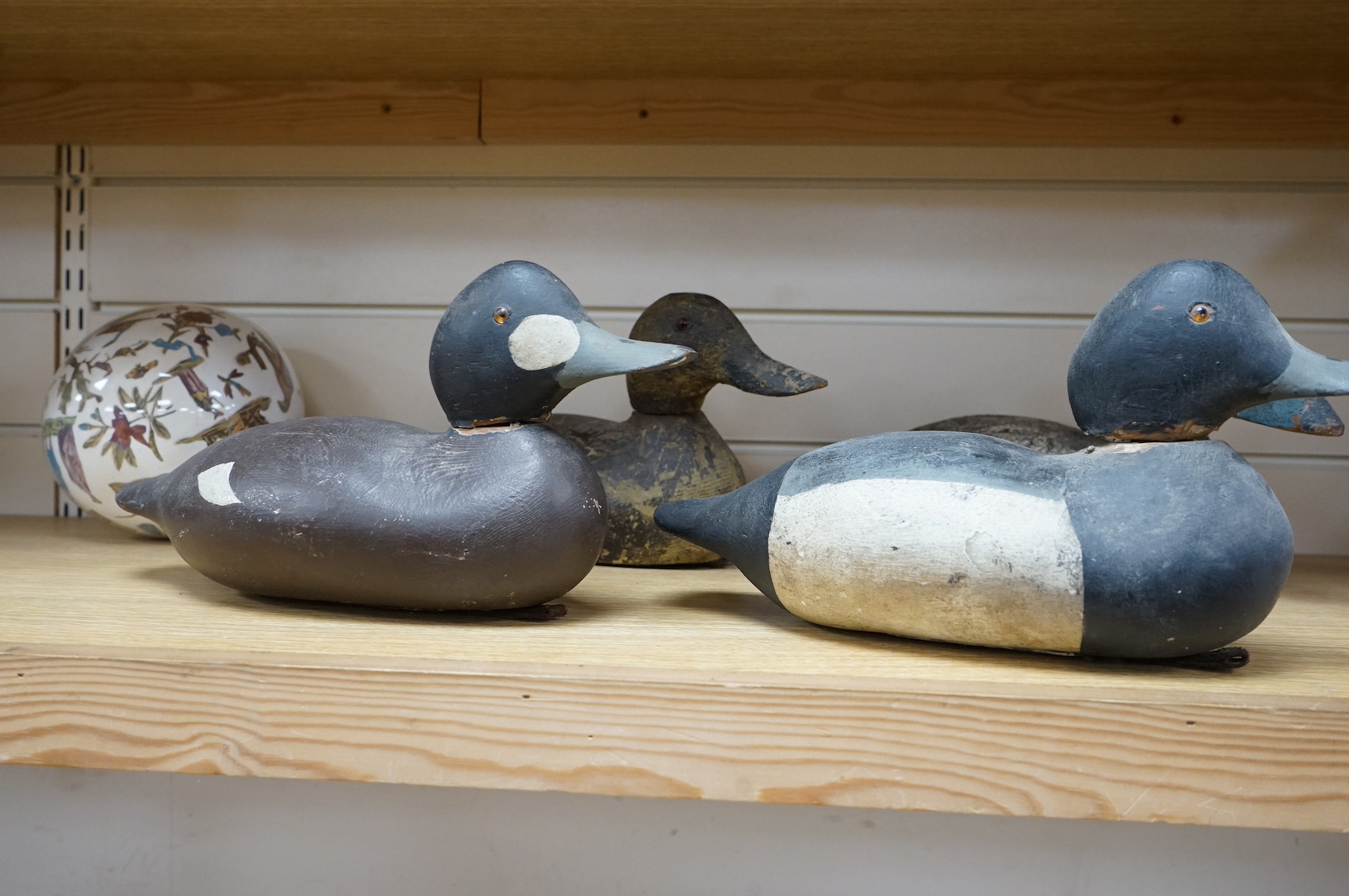 A group of four 19th and 20th century wooden decoy ducks, largest 39cm wide. Condition - fair